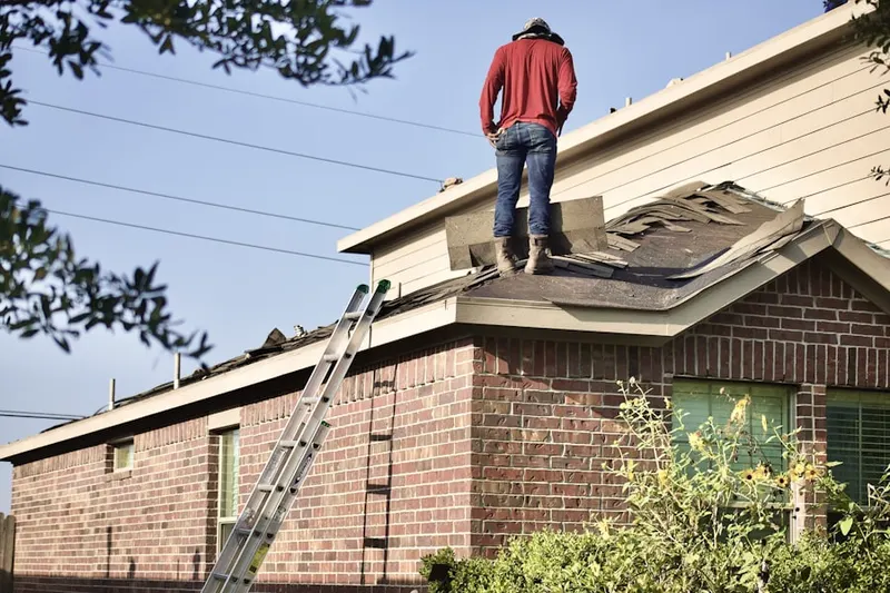 Professional roofer working on a residential roof in Whiting